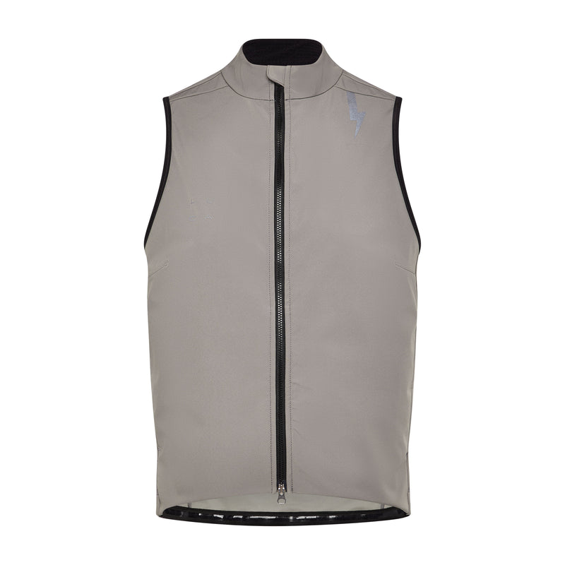 Close-up-detail-of-the-matte-taupe-grey-Luca-cycling-gilet-showcasing-the-full-length-black-zipper-and-high-collar-The-subtle-LUCA-brading-and-the-lighting-bolt-graphic-on-the-shoulder-are-visible-against-the-technical-fabric