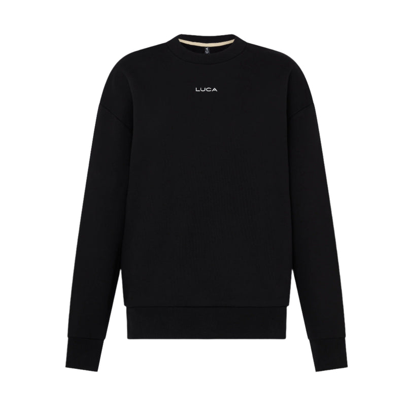 Woman-wearing-a-black-Luca-logo- sweatshirt-and-matching-sweatpants-holding-a-mug-indoors