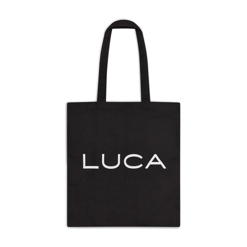 Black-cotton-canvas-tote-bag-with- white-LUCA-logo-printed-on-the- front-with-shoulder-straps-on-a- white-background
