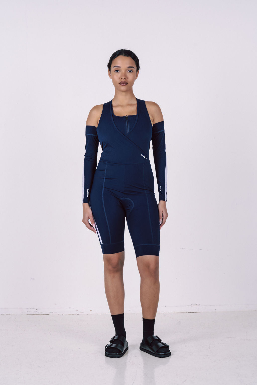 Women's-navy-blue-aerodynamic- speed-suit-featuring-a-sleeveless- top-detachable-cold-shoulder- sleeves-and-white-stripes
