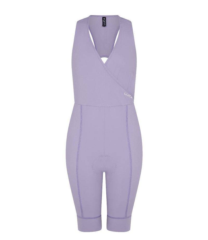 Rear-close-up-of-a-model-wearing- Road-All-In-One-Lilac-over-a-white- sports-bra-The-image-highlights-the-white-racerback-straps-and-the- large-white-lightning-bolt-graphic-on-the-upper-back