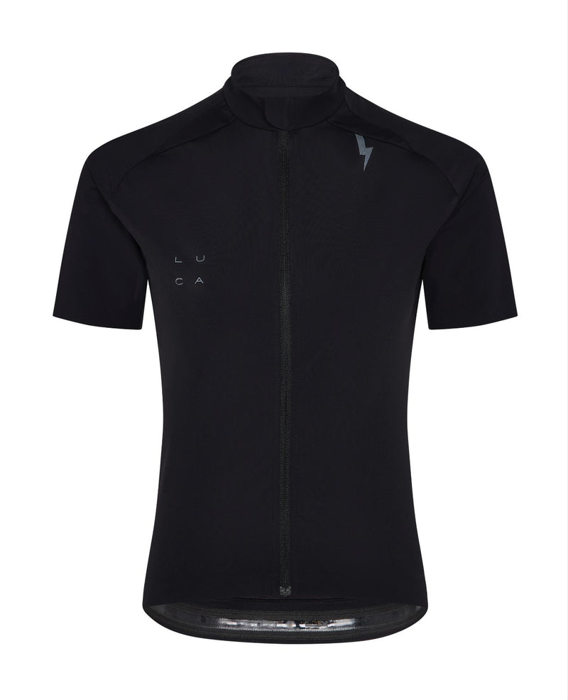 Young-woman-modeling-a-black-short-sleeve-cycling-jersey-with-a-full-zip-a-high-collar-and-a-small-lighting-bolt-sign-on-the-chest