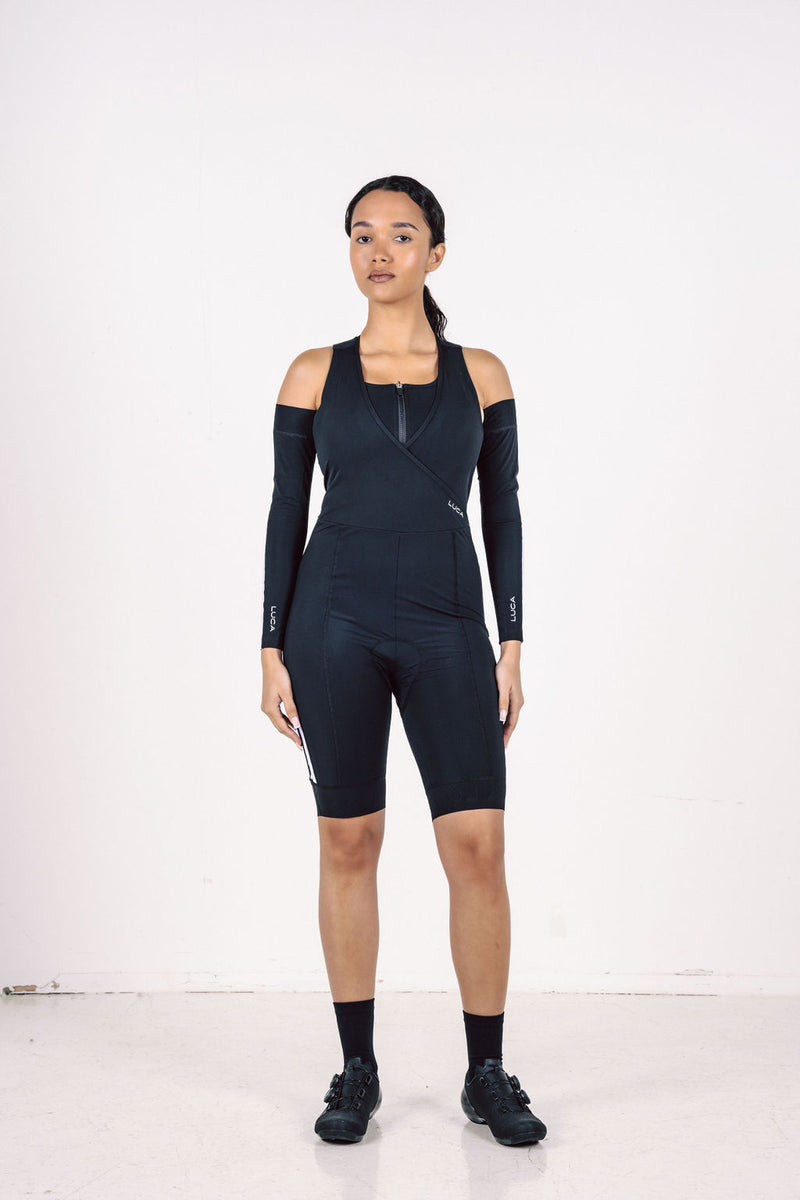 A-pair-of-black-cycling-arm-warmers- shown-flat-against-a-white- background-They-feature-a-single- thick-white-stripe-down-the-side-and- the-small-white-LUCA-logo-near-the- cuff-These-are-essential-unisex-cycling-accessories-black athletic-arm- sleeves-and-sun-protection-gear