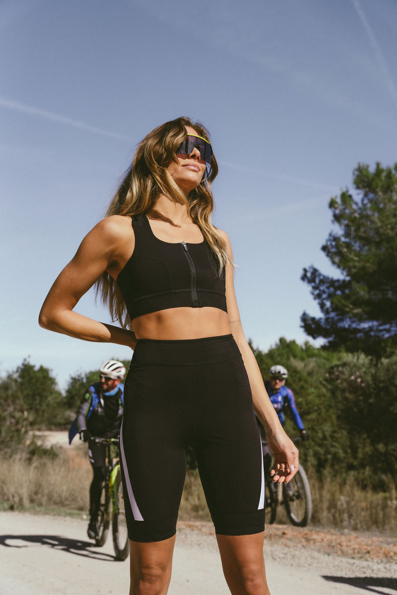 Product-shot-of-black-high-waisted biker-shorts-displayed-against-a- white-background-The-shorts- feature-a-distinctive-white-diagonal- stripe-accent-on-the-lower-sides-of- both-legs-Focus-on-women's-black- biker-shorts-high-waist-cycling- shorts-athletic-workout-gear-and- cycling-shorts
