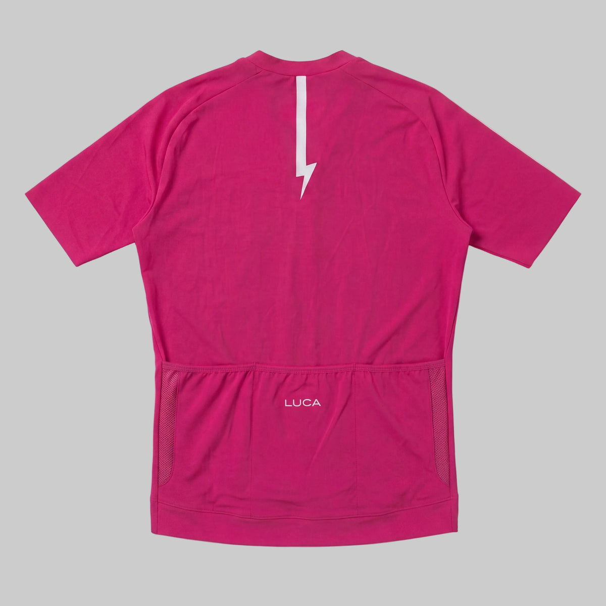 LUCA Soleil women's cycling jersey in hibiscus - back view with reflective bolt and pocket detail